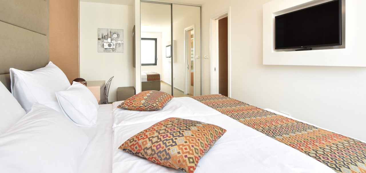 Bedroom With TV Showing