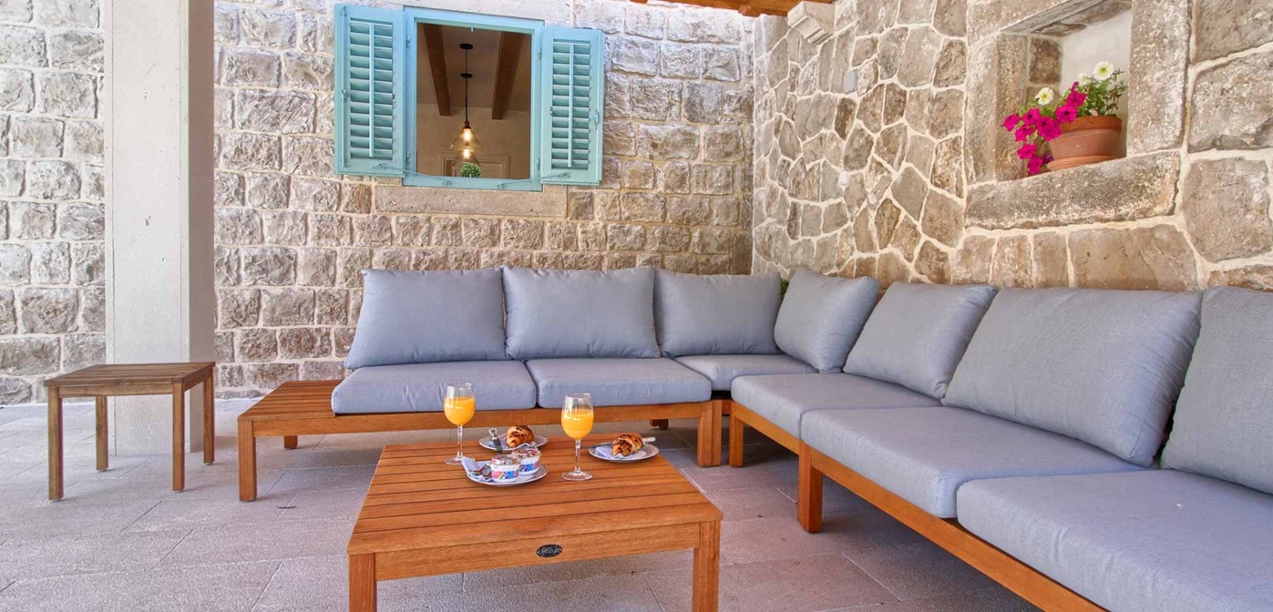 The Stone House Cavtat Patio With Sofa Set And Shuttered Window
