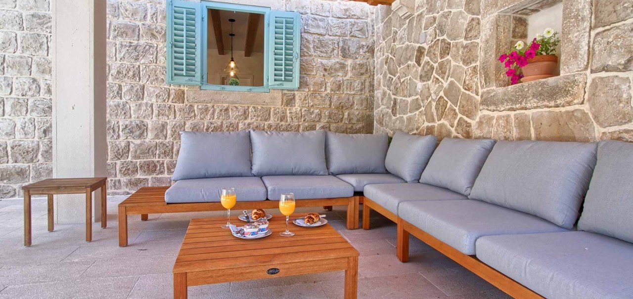 The Stone House Cavtat Patio With Sofa Set And Shuttered Window